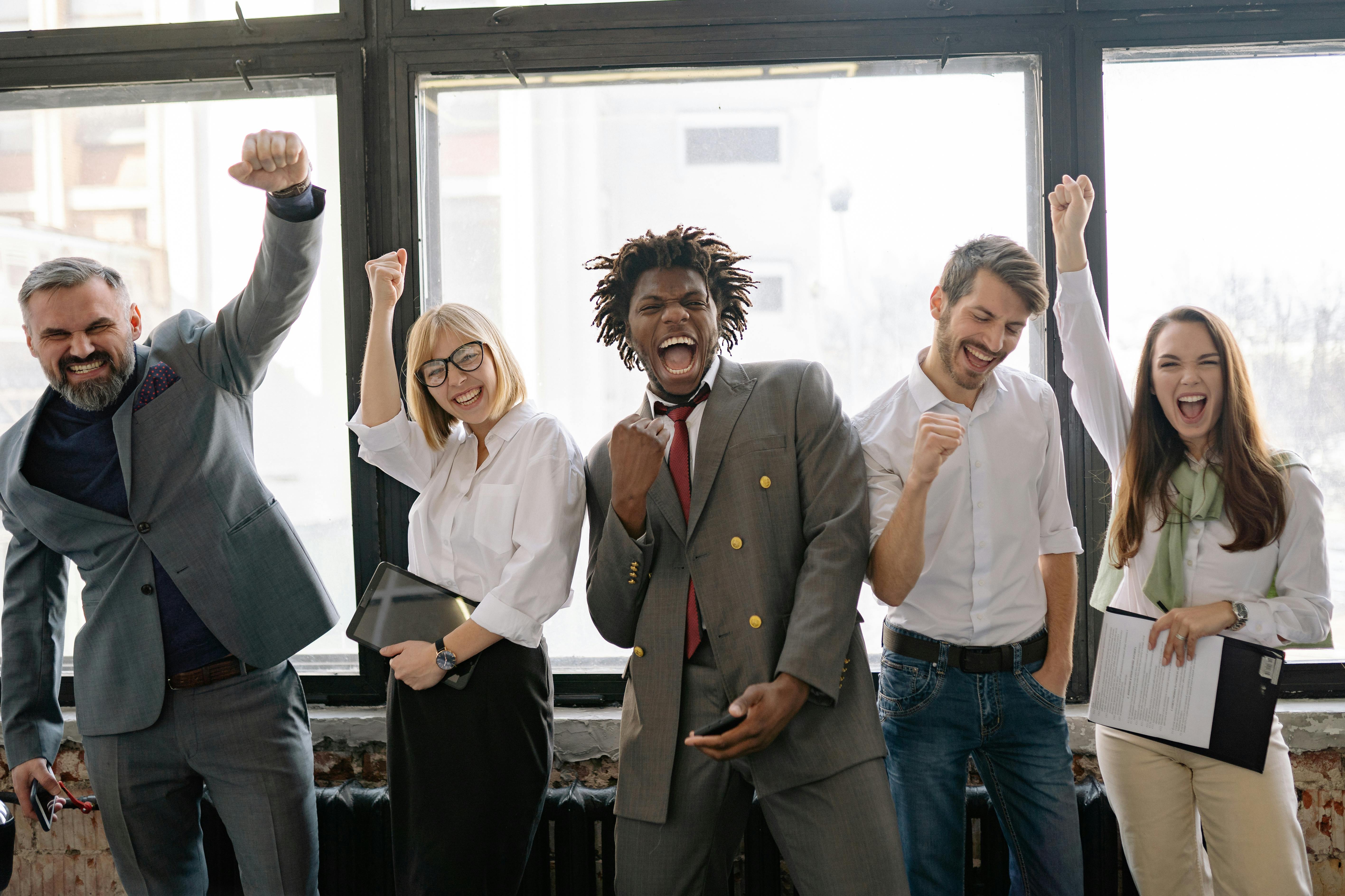 Professionals celebrating success with the fighter's mindset